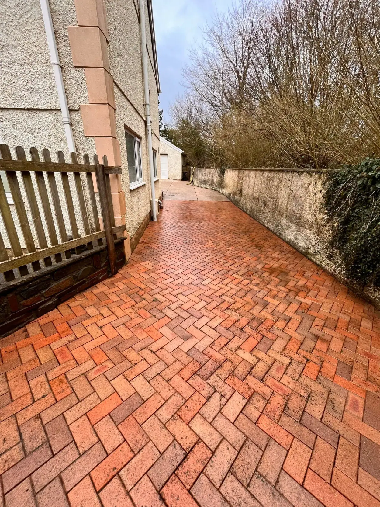 Red brick driveway after professional exterior cleaning